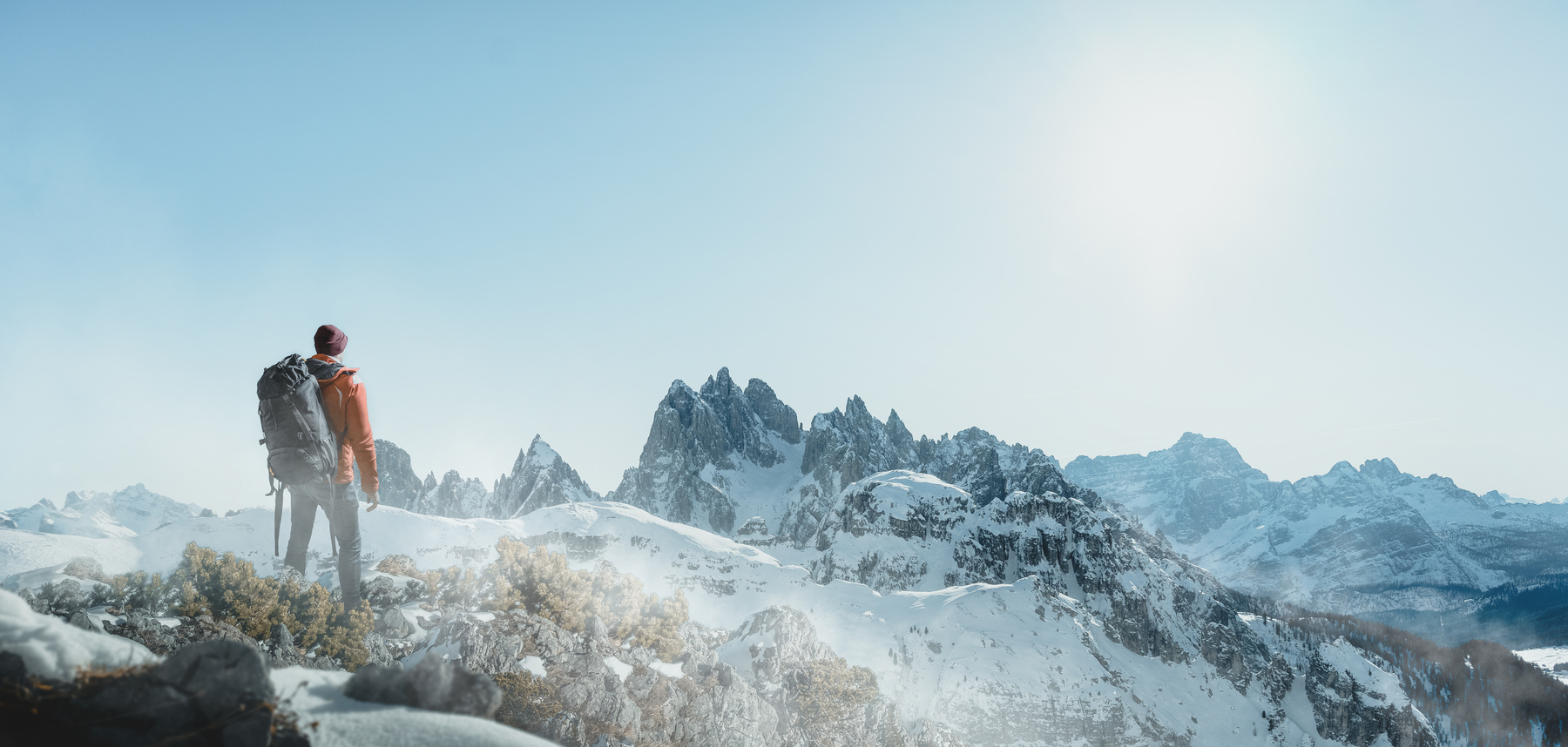 Hiker in snowy mountain landscape